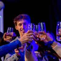 A group of grads cheers on stage